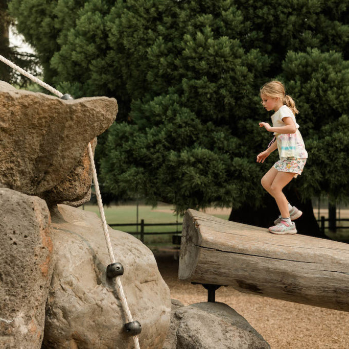 Images of child climbing logs